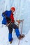 Ice climber with a serious face on the wall of a glacier