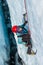 Ice climbing guide down inside a deep crevasse filled with water