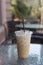 Ice Coffee in plastic take away cup.Outdoor cafe.summer drinking