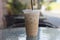 Ice Coffee in plastic take away cup.Outdoor cafe.summer drinking