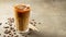 Ice coffee in a tall glass with cream poured over and coffee beans. Cold summer drink on a brown rusty background with copy space