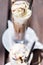 Ice coffee on a wood table with cream being poured into it showing the texture and refreshing look of the drink