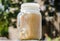 Ice cold brewed coffee and milk froth served in mason jar