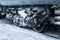 Ice covered bogie of a railway passenger carriage on rails in winter