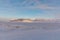 The ice covered fjord Tempelfjorden, with the mountain Templet in the background, and the snowmobile track in the