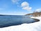 Ice covered pier remnants on cold snowy winter day on Cayuga Lake