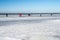 Ice covering an ocean bay. People enjoy the Sunday outing by walking and skating on the ice. Picture from Lomma, Sweden