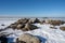 Ice covering an ocean bay. People enjoy the Sunday outing by walking and skating on the ice. Picture from Lomma, Sweden