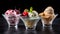 Ice cream bowls on black background. Summer holiday fresh frozen dessert in glass. Vanilla mango berries mint cream with