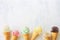 Ice cream cone bottom border with a variety of flavors overhead on a white marble background