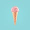 Ice cream cone close-up. Pink Icecream scoop in waffle cone over blue background. Strawberry or raspberry flavor Sweet dessert