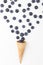 Ice cream cone filled with blueberries