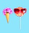 Ice cream cone flowers and colorful lollipop caramel with sunglasses on stick over pink