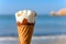 Ice cream cone in front of ocean with soft wave