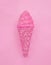 Ice cream cone made from confetti with tasty cream on pink paper background. Trendy minimal pop art style and summer food concept.