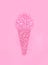 Ice cream cone made from confetti with tropical fashion pink cactus on paper background. Minimal pop art style and summer food con