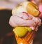 Ice cream cone melting outdoors in summer, sweet dessert food on holiday