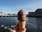 Ice cream in cone with orange brittle and chocolate in the city of Stockholm