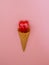 Ice cream cone with red heart lollypop inside