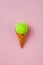 Ice cream cone with tennis ball on pastel pink background. Flat lay