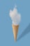 Ice cream cone and white cloud on pastel blue background.