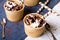 Ice cream in a cup with chocolate sauce and cream rolls