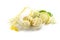 Ice cream from elderberry flowers in a glass bowl, lemon peel and slices and some fresh blossoms isolated on a white background,