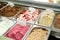 Ice cream fridge with creamy and fruit Italian ice cream steel serving counter with many of refreshing sweet scoopable flavors.