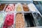 Ice cream fridge with creamy and fruit Italian ice cream steel serving counter with many of refreshing sweet scoopable flavors.