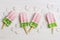 Ice cream pink half green. The concept of summer. Strawberry ice cream on a stick.