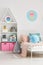 Ice cream poster on white wall above bed in scandi child`s bedro