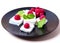 Ice cream with raspberries and mint on a black plate