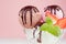 Ice cream scoops - strawberry, chocolate, creamy in bowl with chocolate sauce, mint, spoon, slices berry on pink background.