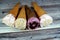 Ice-cream of special flavors in crispy wafer cones, melting cold ice cream twirl in a wafer biscuits  on wooden background