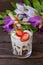 Ice cream with strawberries, mint and muesli. Wooden rustic table.