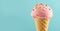 Ice cream. Strawberry or raspberry flavor icecream in waffle cone over blue background. Sweet dessert