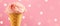 Ice cream. Strawberry or raspberry flavor icecream in waffle cone over pink polka dots background