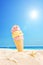 Ice cream stuck in sand on a sunny tropical beach