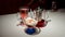 Ice cream with syrup in a glass bowl on a light table, next to a tea punch.