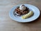 Ice cream on waffle and cocoa powder and banana slice