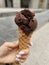 ice cream in a waffle cone chocolate ice cream in hands