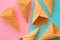 Ice cream waffle cones on pastel pink and blue background