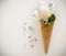 Ice creams immitation in waffle cone decorated mint leaves and flowers. Peonies flower in waffle cone with mint leaves.