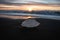 Ice crystal part piece iceberg glacial fragment on black sand ocean waves sunset Diamond Beach Jokulsarlon South Iceland