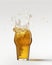 Ice cube falling down. Glass with chill foamy lager beer isolated over grey background. Concept of alcohol, oktoberfest