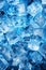 Ice cubes background for summer, pile of frozen icecubes in blue light