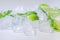Ice cubes with mint and lime on white