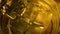 Ice cubes swirl in a glass of golden whiskey. Macro shot. Mixing an alcoholic beverage with bubbles.