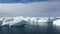 Ice desert shot from above. Polar iceland winter landscape aerial panorama. Frozen ocean, glaciers, icebergs, blue sky