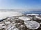 Ice drift on the river in spring. Embankment in the city of Saratov. Sunny day in April